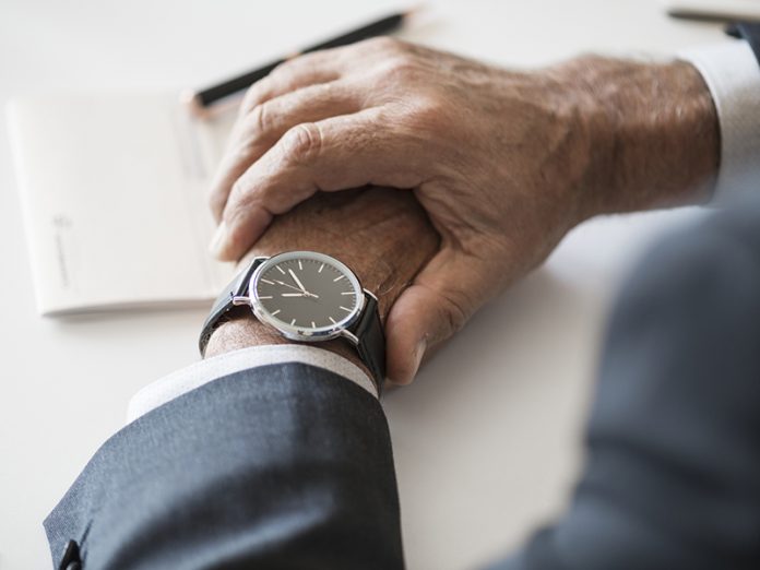 Businessman checking time on hand watch