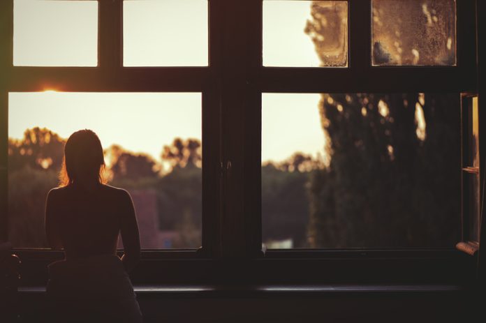 naked woman sitting on a window at sunset What to do when you’re Feeling Anxious