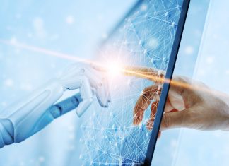 What Every Manager Should Know About Human-Centered AI Hands of robot and human
