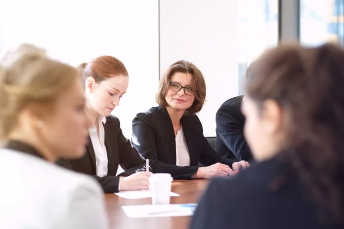 Business partners discussing documents women in leadership