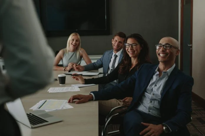 Business people smiling during meeting in board room business meetings tips