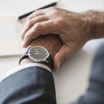 Businessman checking time on hand watch