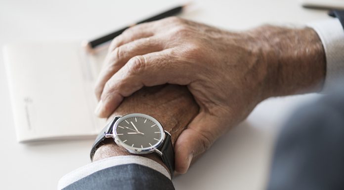 Focal Points Of Watch Over Wear Using A Smartphone Businessman checking time on hand watch