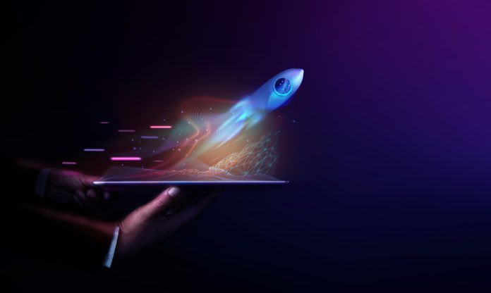 Futuristic Conceptual Photo. Startup Concept. Rocket Take-off and Released from Digital Tablet to Space Launching a New Product in the New Year