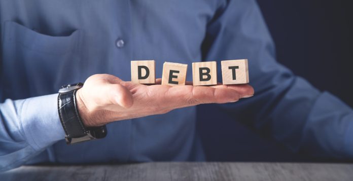 Man holding wooden cubes. Debt. Business concept start a business