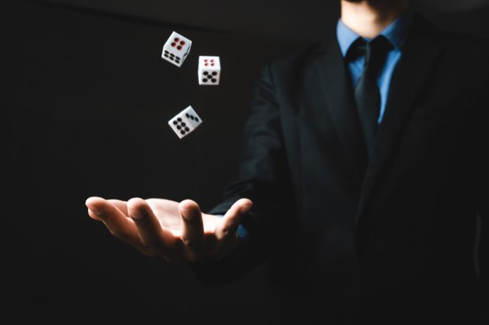 business person hand throw the dice, business gambling game concept back betting