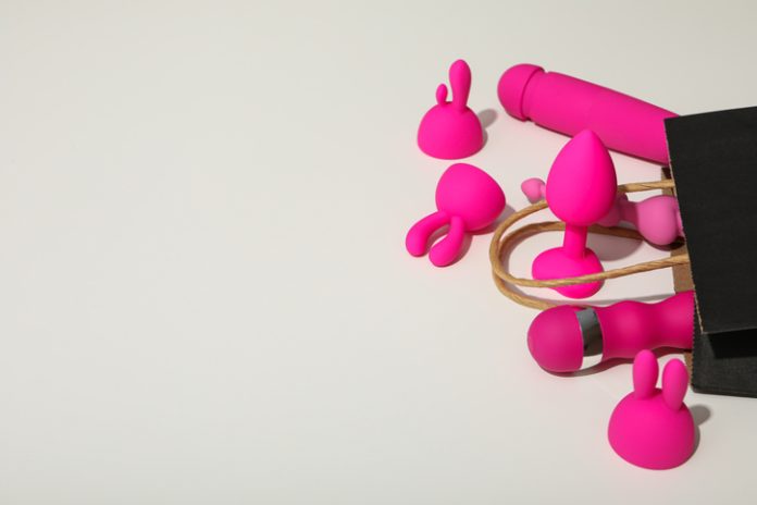 Sex toys spill out of a paper bag, side view toys