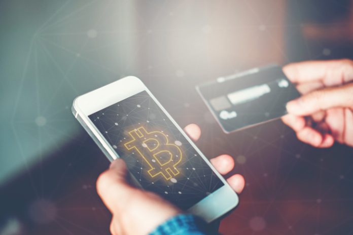 Online banking businessman using smartphone with credit card Fintech and Blockchain concept