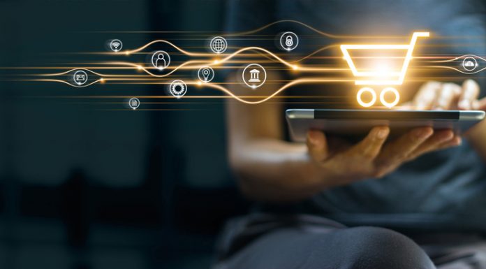 Online shopping and payment, Man using tablet with shopping cart icon, Digital marketing, Banking and finance on dark blue background.