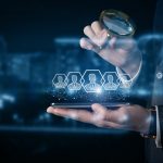 A businessman examines customers on his phone .