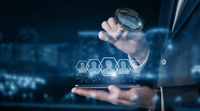 Basic Features to Look for in HR Software for Small Enterprises A businessman examines customers on his phone .