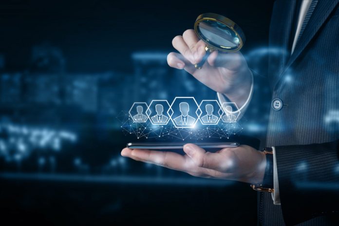 A businessman examines customers on his phone .