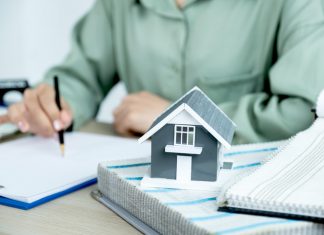 Home model standing in front of the property and interior agents are presenting houses and curtains for interior decoration.
