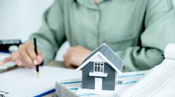 Home model standing in front of the property and interior agents are presenting houses and curtains for interior decoration.
