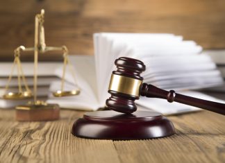 Conciliation Trumps Conflict: The Rise of Out-of-Court Settlements Scales of justice and Gavel on wooden table and Lawyer or Judge working with agreement in Courtroom, Justice and Law concept