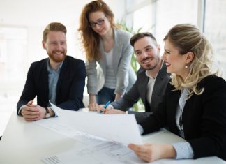 4 Reasons to Why Businesses Need Key Person Insurance Business coworkers discussing new ideas and brainstorming in a modern office