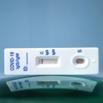 Covid-19 test on top of a round glass surface, similar to globe