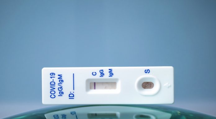 How Accurate Are Covid-19 Lateral Flow Tests? Covid-19 test on top of a round glass surface, similar to globe