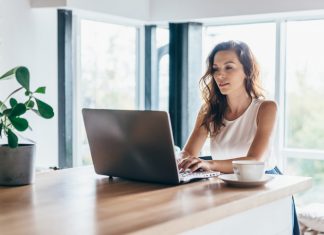 Working Your Side Hustle Through a Pandemic Woman using laptop while sitting at home.