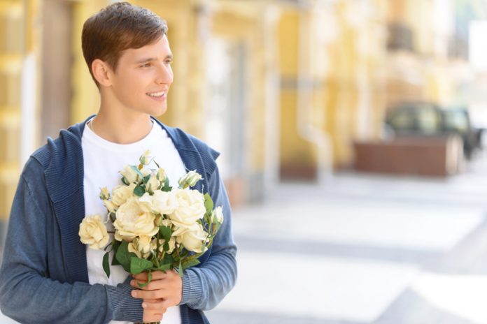 Handsome guy holding flowers gift-giving rules for men