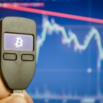 What is a Brain Wallet and How Can You Secure It? Close-up of a male hand holds a wallet for storing e-money, bitcoin, cryptocurrency, bitcoin graphic.