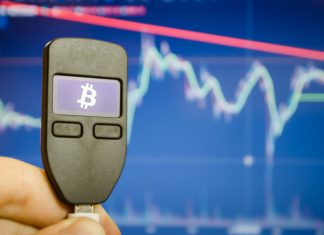 Close-up of a male hand holds a wallet for storing e-money, bitcoin, cryptocurrency, bitcoin graphic.