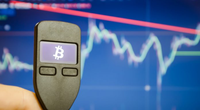 Close-up of a male hand holds a wallet for storing e-money, bitcoin, cryptocurrency, bitcoin graphic.