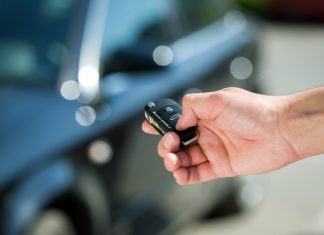 Man hand press the remote control car alarm systems