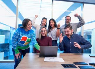 Group of motivated employees celebrating as a team.