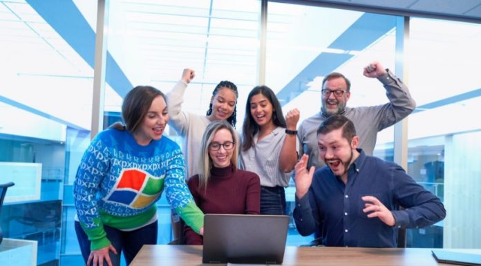 5 Tips to Help Business Owners Motivate Their Staff Group of motivated employees celebrating as a team.