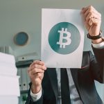 businessman-holding-document-paper-with-bitcoin
