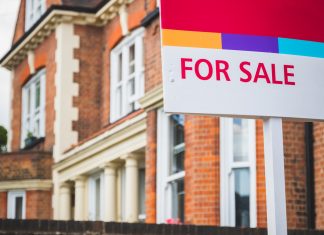 For Sale sign displayed outside a terraced house in Crouch End, London
