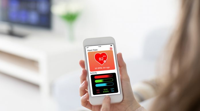 Female hands holding phone with app health tracking activity screen