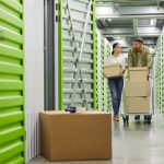 7 Ways to Kickstart Your Self Storage Business Couple Moving Boxes in Storage Unit