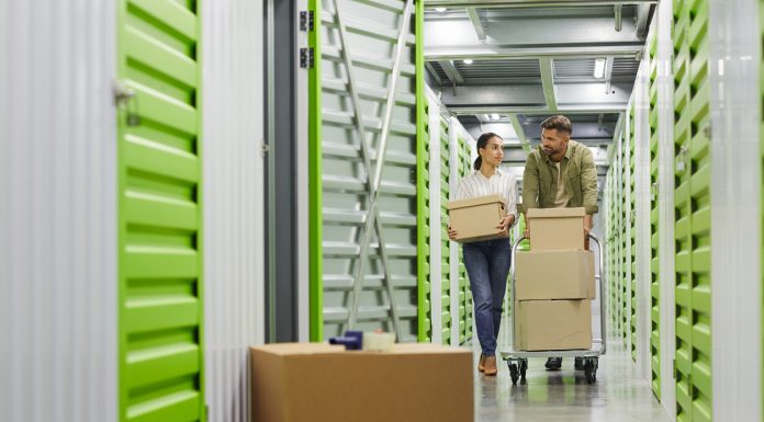 Couple Moving Boxes in Storage Unit