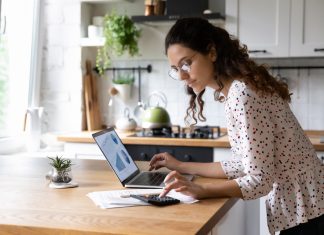 6 Tips to Save Money on Your Next Move from Professional Movers Serious woman wearing glasses calculating finances, working with project statistics