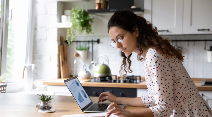 6 Tips to Save Money on Your Next Move from Professional Movers Serious woman wearing glasses calculating finances, working with project statistics