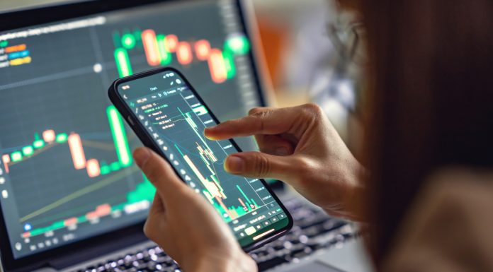 What Is The Meaning Of Lending Crypto? Let’s Find Out Woman is checking Bitcoin price chart on digital exchange on smartphone, cryptocurrency future price action prediction.