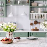 Kitchen countertop with flowers in bucket and jar