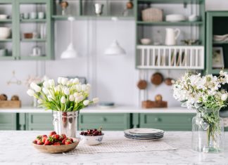 Keep Or Leave? The Toughest Items To Move Between Homes Kitchen countertop with flowers in bucket and jar