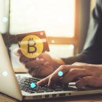 Bitcoin ATM: Here Is What You Need To Know internet banking network and cryptocurrency concept. Man hand using credit card for trade cryptocurrency.