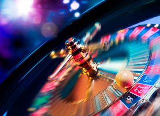 Roulette wheel in motion with a bright and colorful background