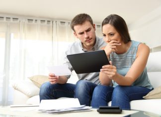 Worried couple checking bank account online
