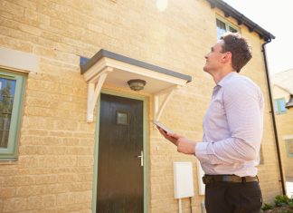 Essential Career Advice for Real Estate Agents Male real estate agent looking up at a house exterior