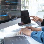 Three Big Benefits Of Hiring Web Development Services Professional Developer programmer cooperation meeting and brainstorming and programming in website working a software outsourcing and coding technology, writing codes and database