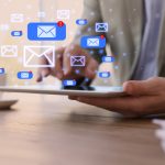 5 Best Alternatives of Messaging Apps like Slack Businessman sending emails at wooden table in office, closeup