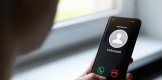 woman holding mobile phone with incoming call from unknown caller