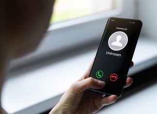 woman holding mobile phone with incoming call from unknown caller