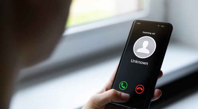 woman holding mobile phone with incoming call from unknown caller