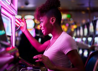 Online Casino is the Future of Entertainment happy woman gambling at casino playing slot machine